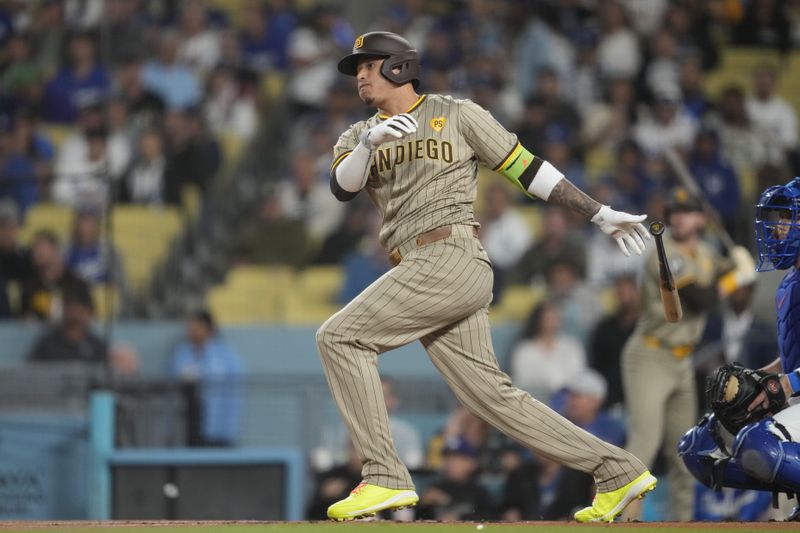 San Diego Padres' Manny Machado watches his single during the first inning of a baseball game against the Los Angeles Dodgers, Thursday, Sept. 26, 2024, in Los Angeles. (AP Photo/Ashley Landis)