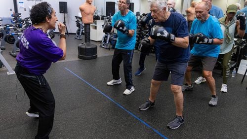 Nausheen Quraishy (left), a Rock Steady Boxing instructor, runs a class in which people with Parkinson's disease exercise and try to regain their strength at the Kennestone Health Place at Kennestone Hospital in Kennesaw. After suffering an AVM rupture 18 years ago, doctors said she had "no reason to be alive and functioning." She used her own personal battles to help her inspire others to fight for their future. PHIL SKINNER FOR THE ATLANTA JOURNAL-CONSTITUTION