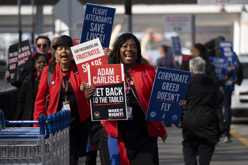 Airline employees including Veronica Espinoza, a Southwest flight attendant, picket outside of the North Terminal at Hartsfield-Jackson International Airport in Atlanta on Tuesday, Feb. 13, 2024.   (Ben Gray / Ben@BenGray.com)