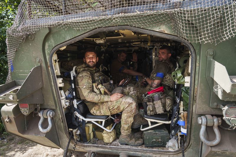 FILE - Ukrainian servicemen sit in their armored personnel carrier in Ukraine’s Sumy region on Aug. 14, 2024, after returning from Russia’s Kursk region. (AP Photo/Evgeniy Maloletka, File)