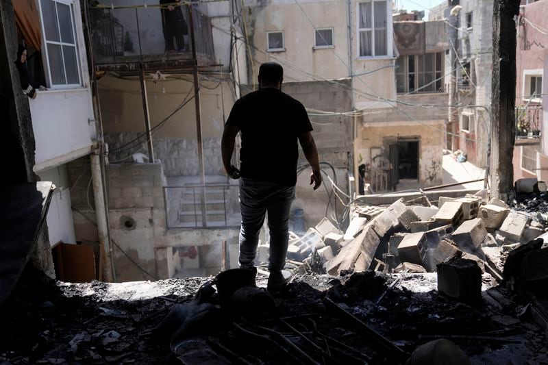 Palestinians inspect the destruction following an Israeli operation in Nur Shams refugee camp, near the West Bank town of Tulkarem, Monday, July 1, 2024. Palestinian health officials say a woman and a teenager were shot and killed, and four people were wounded by Israeli forces during a raid in the northern West Bank. (AP Photo/Majdi Mohammed)