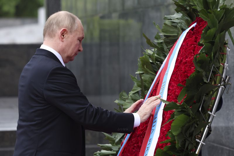 Russia's President Vladimir Putin lays a wreath at the Ho Chi Minh Mausoleum during his visit to Hanoi, Vietnam Thursday, June 20, 2024. (Athit Perawongmetha/Pool Photo via AP)