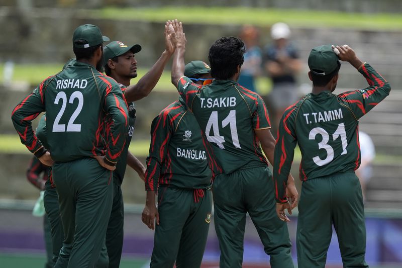 Bangladesh's Tanzim Hasan, second right, celebrates with teammates after the dismissal of India's Virat Kohli during the ICC Men's T20 World Cup cricket match between India and Bangladesh at Sir Vivian Richards Stadium in North Sound, Antigua and Barbuda, Saturday, June 22, 2024. (AP Photo/Lynne Sladky)