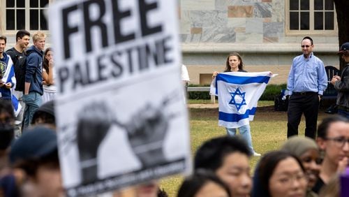 A person with an Israel flag counter-protests a student walkout and rally in support of Palestine at Emory University in Atlanta on Thursday, September 12, 2024. (Arvin Temkar / AJC)