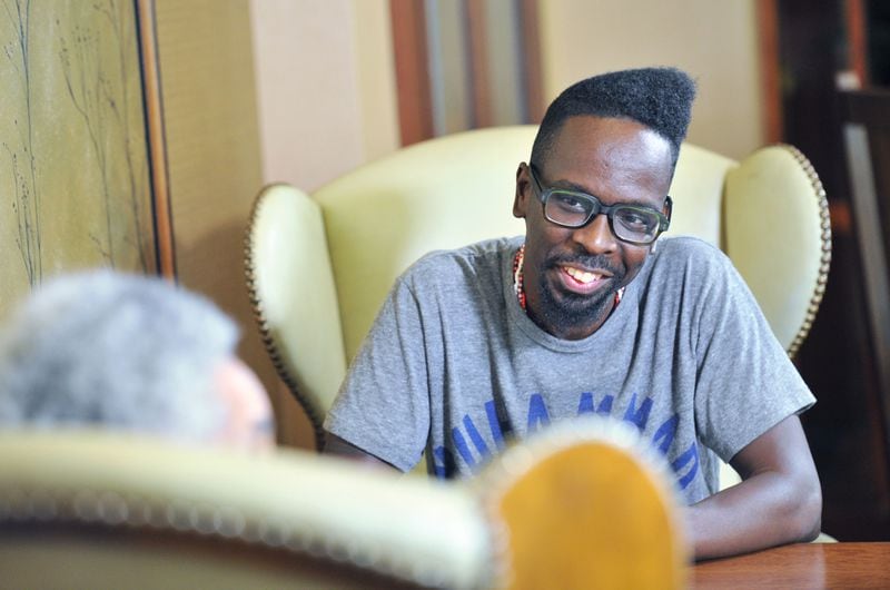 September 15, 2016 Atlanta - Atlanta based artist Fahamu Pecou reacts as he listens to filmmaker, sculptor and provocateur Camille Billops (foreground) at Emory University Conference Center Hotel on Thursday, September 15, 2016. Both have made careers exploring black identity and representation in art. Pecou’s work is in the permanent collection of the new Smithsonian African American musuem, Billops’ work is taught in colleges around the country. HYOSUB SHIN / HSHIN@AJC.COM