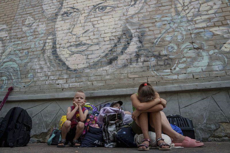 People wait for evacuation in Pokrovsk, Donetsk region, Ukraine, Friday, Aug. 23, 2024. (AP Photo/Evgeniy Maloletka)