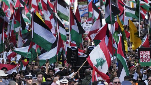 People march on the street as Pro-Palestinian supporters rally in Sydney, Sunday, Oct. 6, 2024. (AP Photo/Rick Rycroft)