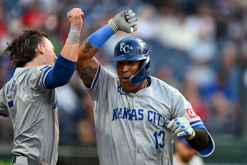 Kansas City Royals' Salvador Perez (13) and Bobby Witt Jr., left, celebrate after a solo home run by Perez during the fifth inning of the second game of a baseball doubleheader against the Cleveland Guardians, Monday, August 26, 2024, in Cleveland. (AP Photo/Nick Cammett)