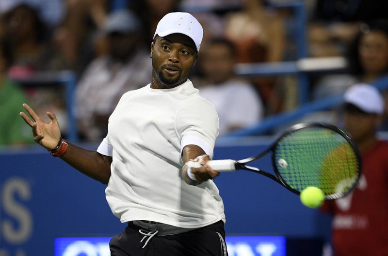 FILE - Donald Young, of the United States, returns the ball to Kei Nishikori, of Japan, during the Citi Open tennis tournament, Aug. 1, 2018, in Washington. (AP Photo/Nick Wass, File)