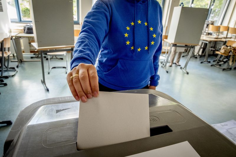 A woman casts her ballot for the European elections in a polling station in Frankfurt, Germany, Sunday, June 9, 2024. (AP Photo/Michael Probst)