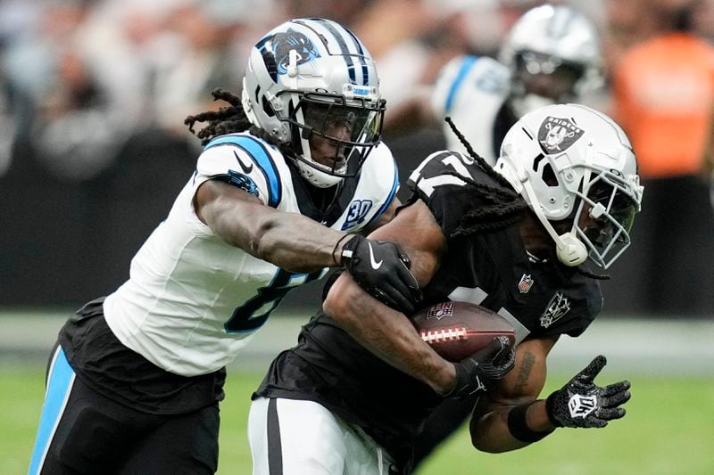 Las Vegas Raiders wide receiver Davante Adams is tackled by Carolina Panthers cornerback Jaycee Horn during the first half of an NFL football game, Sunday, Sept. 22, 2024, in Las Vegas. (AP Photo/John Locher)