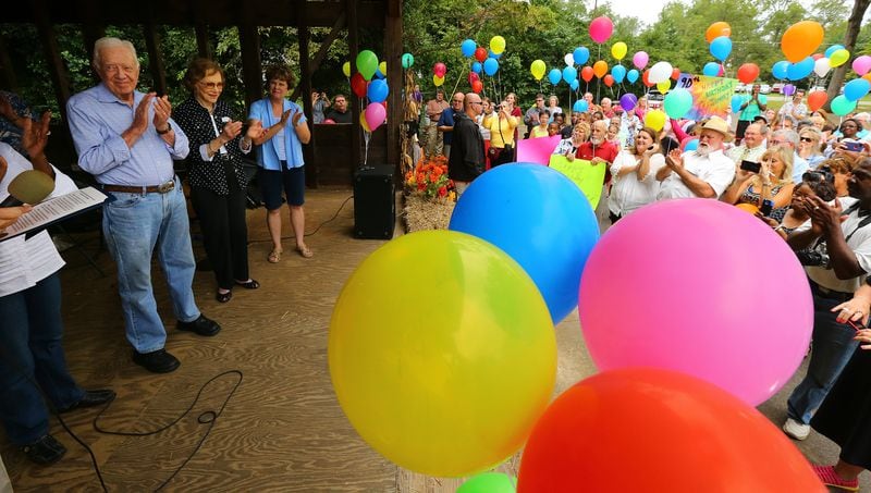 Former President Jimmy Carter and former first lady Rosalynn Carter applaud along with the crowd after Mayor L.E. Godwin finishes reading a birthday proclamation during the President's 90th birthday party at Maxine Reese Park on Sunday, Sept. 28, 2014, in Plains, Georgia. CURTIS COMPTON / CCOMPTON@AJC.COM