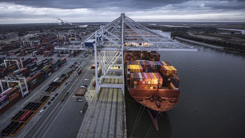 In this photo provided by the Georgia Ports Authority, eight ship-to-shore cranes work the container ship Ulsan Express at the Georgia Ports Authority's Garden City Terminal, on Wednesday, Feb. 2, 2022, in Savannah, Ga. (Stephen B. Morton/Georgia Port Authority via AP)