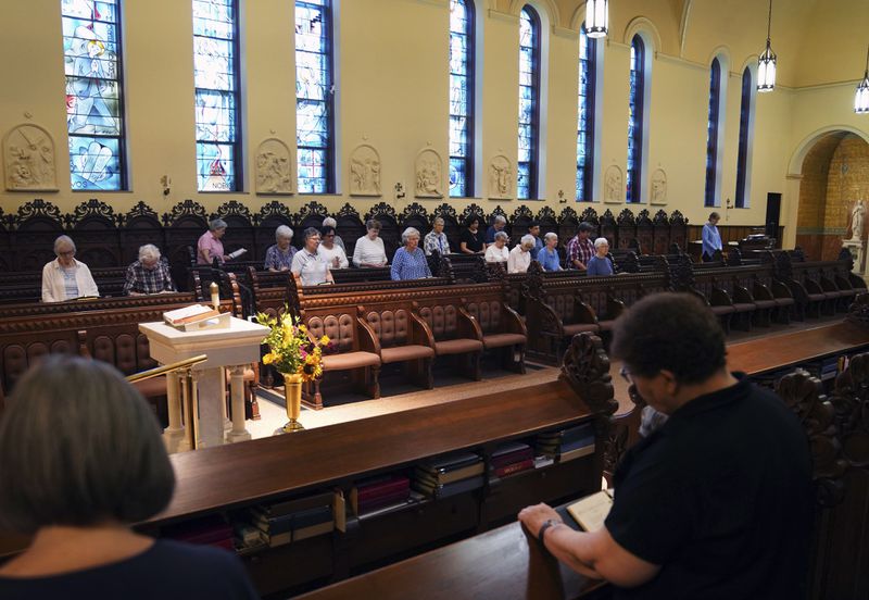 Benedictine sisters join in song during morning prayer at the Mount St. Scholastica monastery in Atchison, Kan., Wednesday, July 17, 2024. (AP Photo/Jessie Wardarski)