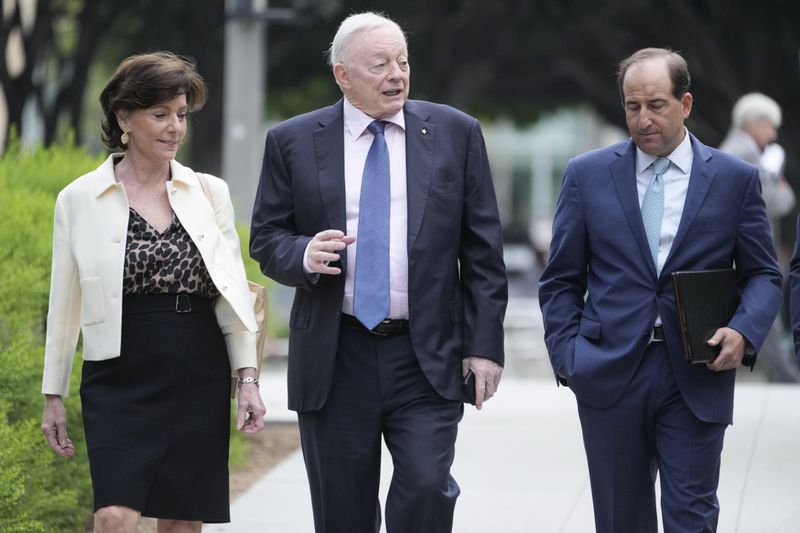 Dallas Cowboys owner Jerry Jones, center, arrives at federal court Tuesday, June 18, 2024, in Los Angeles. Jones is testifying in a class-action lawsuit filed by "Sunday Ticket" subscribers claiming the NFL broke antitrust laws. (AP Photo/Damian Dovarganes)