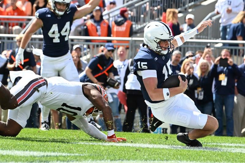 Penn State quarterback Drew Allar (15) scores a touchdown ahead of Bowling Green linebacker Donny Stephens (10) during the first quarter of an NCAA college football game, Saturday, Sept. 7, 2024, in State College, Pa. (AP Photo/Barry Reeger)