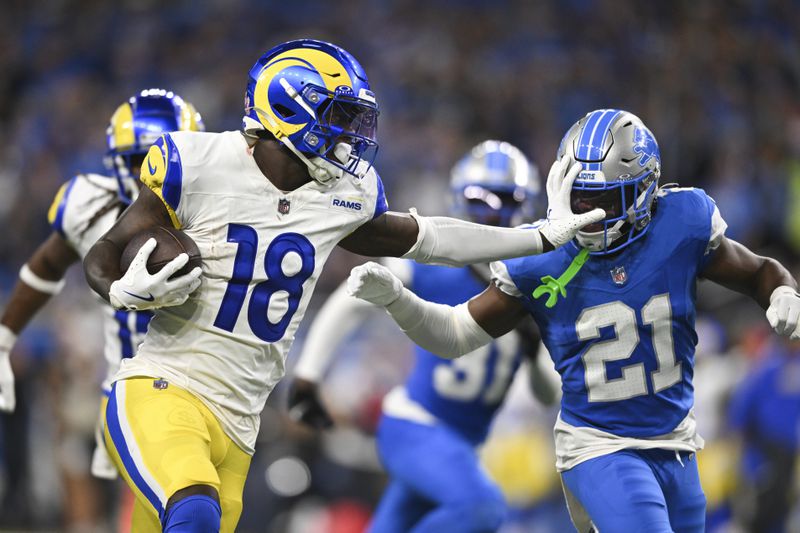 Los Angeles Rams wide receiver Tyler Johnson (18) stiff-arms Detroit Lions cornerback Amik Robertson (21) during a 63-yard reception during the second half of an NFL football game in Detroit, Sunday, Sept. 8, 2024. (AP Photo/David Dermer)