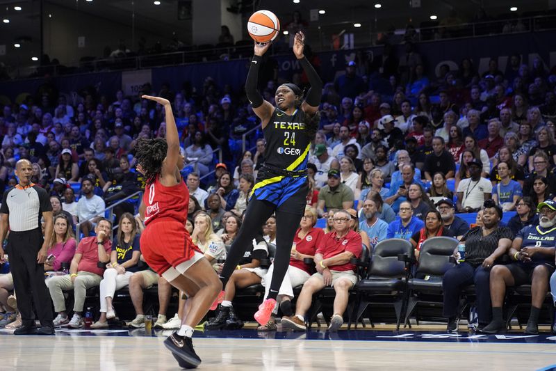 Dallas Wings guard Arike Ogunbowale takes a shot as Indiana Fever's Kelsey Mitchell (0) defends in the second half of a WNBA basketball game Sunday, Sept. 1, 2024, in Arlington, Texas. (AP Photo/Tony Gutierrez)