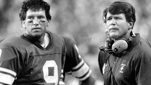 FILE - Minnesota Vikings head coach Les Steckel and quarterback Tommy Kramer, left, survey the damage from the sidelines as they watch the San Diego Chargers ruin Steckel's coaching debut with a 42-13 rout in Minneapolis, Sept. 3, 1984. (AP Photo/Larry Salzman, File)