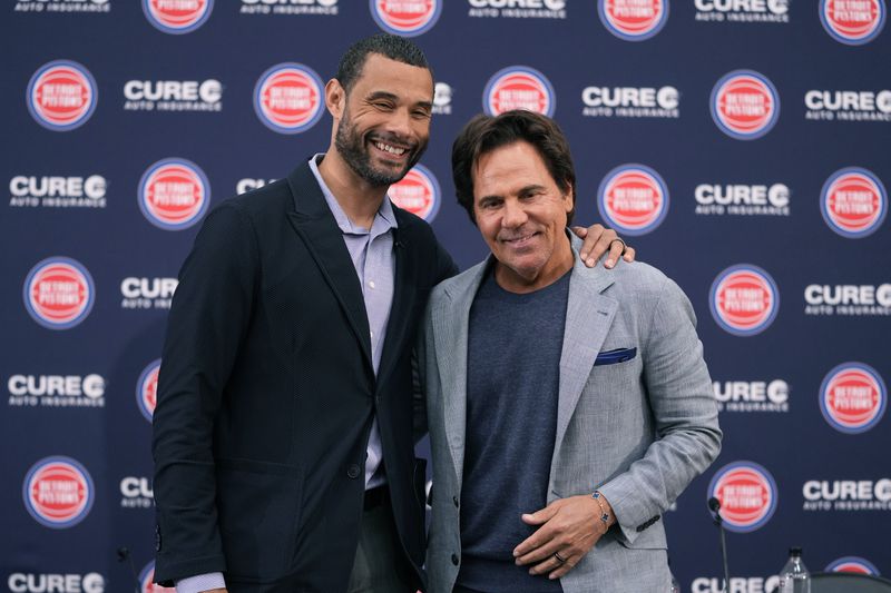 Detroit Pistons Owner Tom Gores, right, and President of Basketball Operations Trajan Langdon pose after addressing the NBA basketball media, Friday, June 21, 2024, in Detroit. (AP Photo/Carlos Osorio)