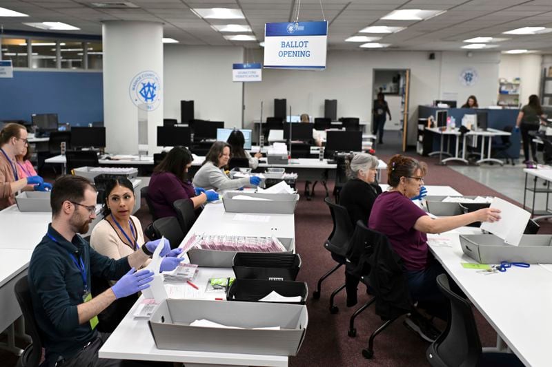 FILE - County employees open ballots in the mail ballot processing room at the Washoe County Registrar of Voters office in Reno, Nev., June 3, 2024. (AP Photo/Andy Barron, File)