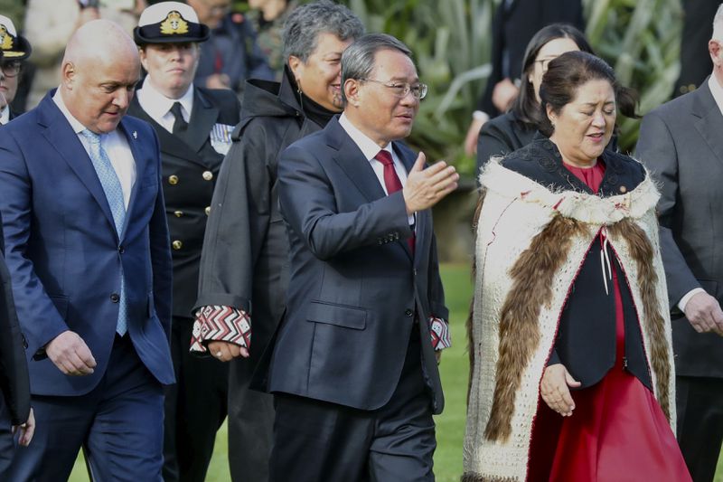 Chinese Premier Li Qiang, centre, stands with New Zealand Prime Minister Christopher Luxon, left, and New Zealand Governor General Dame Cyndi Kiro during the official welcome ceremony in Wellington, New Zealand, Thursday, June 13, 2024. Li has arrived in New Zealand at the start of a weeklong tour that also includes Australia and Malaysia. (Mark Mitchell/NZ Herald via AP)