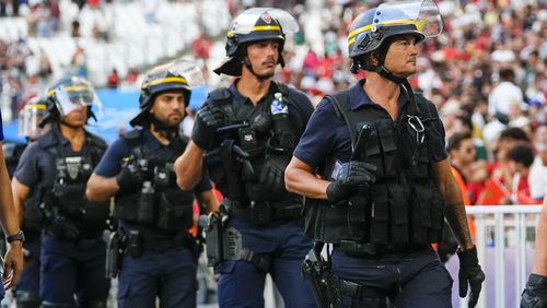 FILE - Police are seen near the pitch during a men's semifinal soccer match between Morocco and Spain at the 2024 Summer Olympics, Monday, Aug. 5, 2024, at Marseille Stadium in Marseille, France. Spain won 2-1. (AP Photo/Julio Cortez, File)