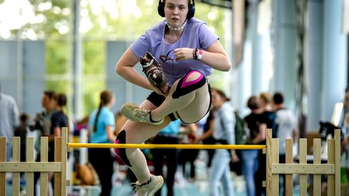 A girl clears the bar during the first German Hobby Horsing Championship in Frankfurt, Germany, Saturday, Sept. 14, 2024. (AP Photo/Michael Probst)