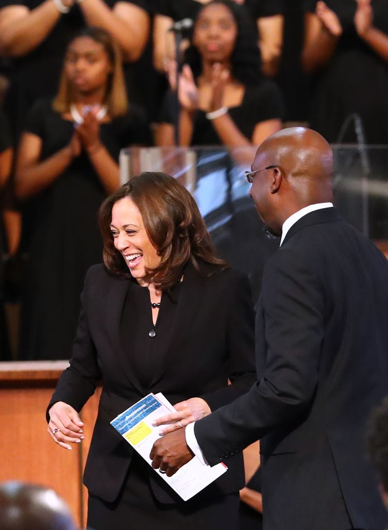 The Rev. Raphael Warnock introduces Kamala Harris, now the vice president-elect, during a worship service in March at Ebenezer Baptist Church. Republicans have seized on Warnock's sermons in efforts to cast him as too radical for Georgia. But Warnock stresses that now is the time for a pastor to serve in the U.S. Senate because he says the country is suffering from a "spiritual crisis." Curtis Compton/ccompton@ajc.com