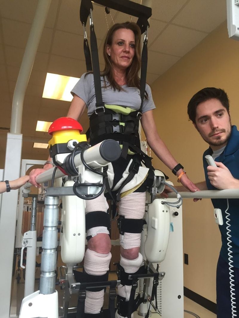 Janet Paulsen gets help moving her legs during a therapy session at the Shepherd Center. CONTRIBUTED