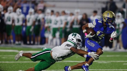 McEachern’s Zavion Harris (14) runs the ball during a GHSA High School football game between Harrison High School and McEachern High School at McEachern High School in  Powder Springs, GA., on Friday, October 4, 2024. (Photo/Jenn Finch, AJC)