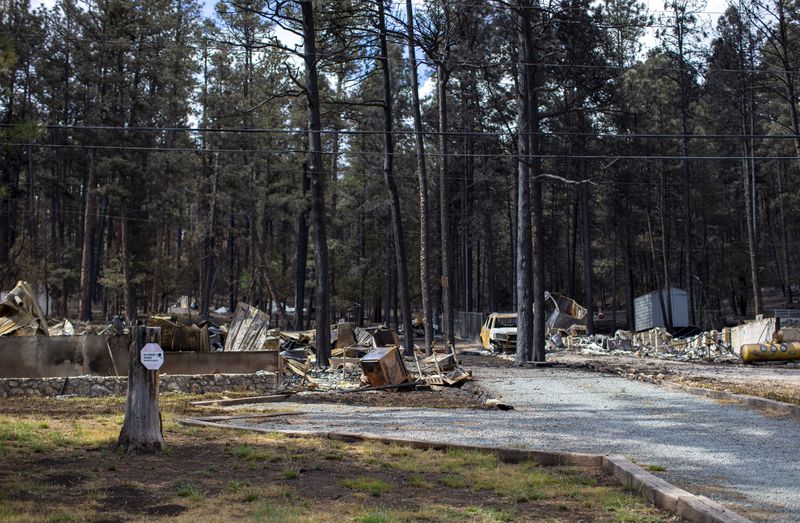 Houses destroyed by the South Fork Fire are pictured in the mountain village of Ruidoso, N.M., Saturday, June 22, 2024. . (AP Photo/Andres Leighton)