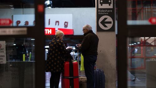 Travelers wait at the designated rideshare area at Hartsfield-Jackson Atlanta International Airport , Monday, Jan. 2, 2017, in Atlanta. BRANDEN CAMP/SPECIAL