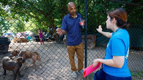 Tracy Woodard from InTown Cares, an outreach group that serves people experiencing homelessness in metro Atlanta, speaks with a Cooper Street encampment resident, Willie Jeffries, 60, on Monday, Aug. 12, 2024, in Atlanta. (Miguel Martinez / AJC)