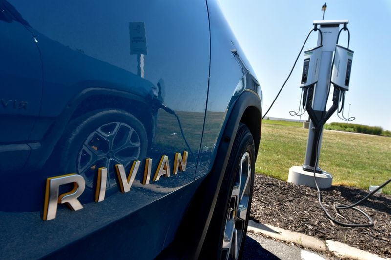 The Rivian R1T electric vehicle is connected to a charging station outside the Rivian Plant in Normal, Illinois, on July 20, 2022. (Photo for the Atlanta Journal-Constitution by Ron Johnson)