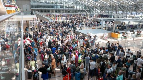 Travelers wait in Terminal 1 for check-in at Hamburg Airport, in Hamburg, Germany, Friday July 19, 2024 as a widespread Microsoft outage disrupted flights, banks, media outlets and companies around the world on Friday. (Bodo Marks/dpa via AP)