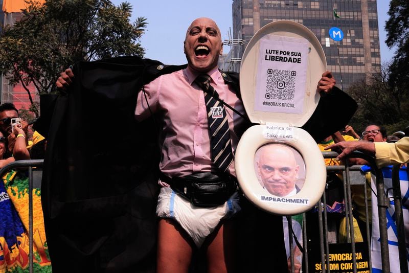 A protester, dressed to depict Supreme Court Minister Alexandre de Moraes wearing a diaper, takes part in a protest calling for the impeachment of de Moraes, who recently imposed a nationwide block on Elon Musk's social media platform X, in Sao Paulo, Saturday, Sept. 7, 2024. (AP Photo/Ettore Chiereguini)