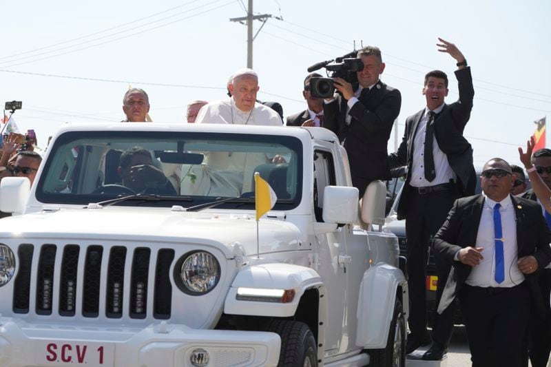 Pope Francis in a car, is welcomed in Dili, East Timor, Monday, Sept. 9, 2024. (AP Photo/Firdia Lisnawati)