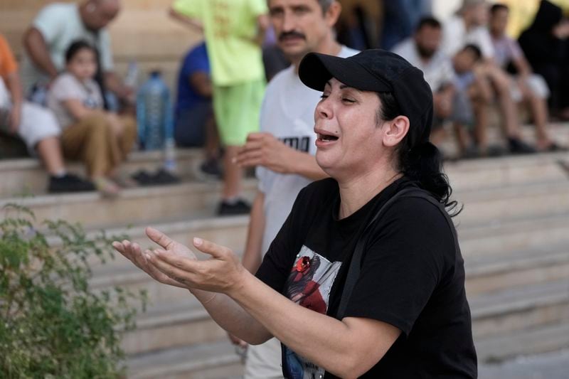 A woman reacts to the news of the death of Hezbollah leader Hassan Nasrallah in Beirut, Saturday, Sept. 28, 2024. (AP Photo/Bilal Hussein)