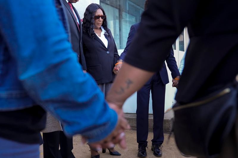 RowVaughn Wells, left, mother of Tyre Nichols, prays with family and friends before entering the federal courthouse for the trial of three former Memphis police officers charged in the 2023 fatal beating of her son Wednesday, Oct. 2, 2024, in Memphis, Tenn. (AP Photo/George Walker IV)