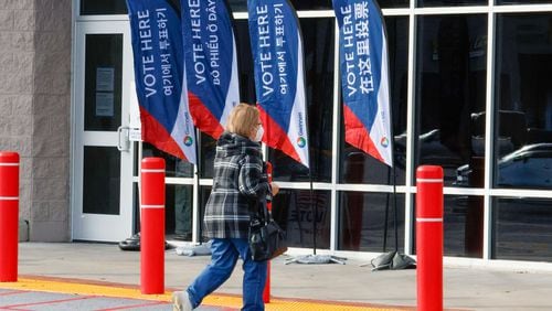 A person walks toward the Gwinnett County elections office during the first day of early voting for the Georgia presidential primary on Monday, Feb 19, 2024. (Miguel Martinez / miguel.martinezjimenez@ajc.com)