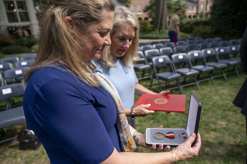 Alexia Collart, left, holds The Navy and Marine Corps Medal, the USMCs highest non-combat medal, that was posthumously awarded to her son, Cpl. Spencer Collart, during a ceremony on Monday, Sept. 16, 2024 in Washington. (AP Photo/Kevin Wolf)