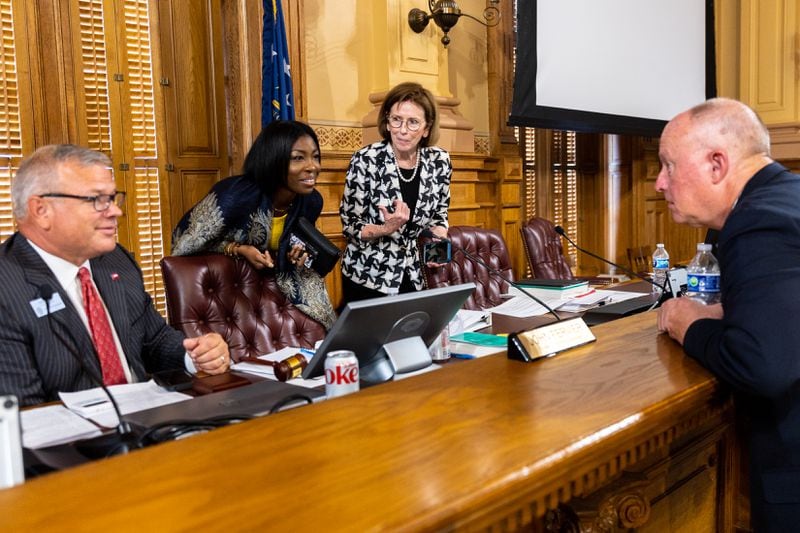 (L-R) State Election Board Executive Director Mike Coan and members Janelle King, Janice Johnston, and Rick Jeffares speak during a break at the board meeting at the Capitol in Atlanta on Tuesday, July 9, 2024. (Arvin Temkar / AJC)