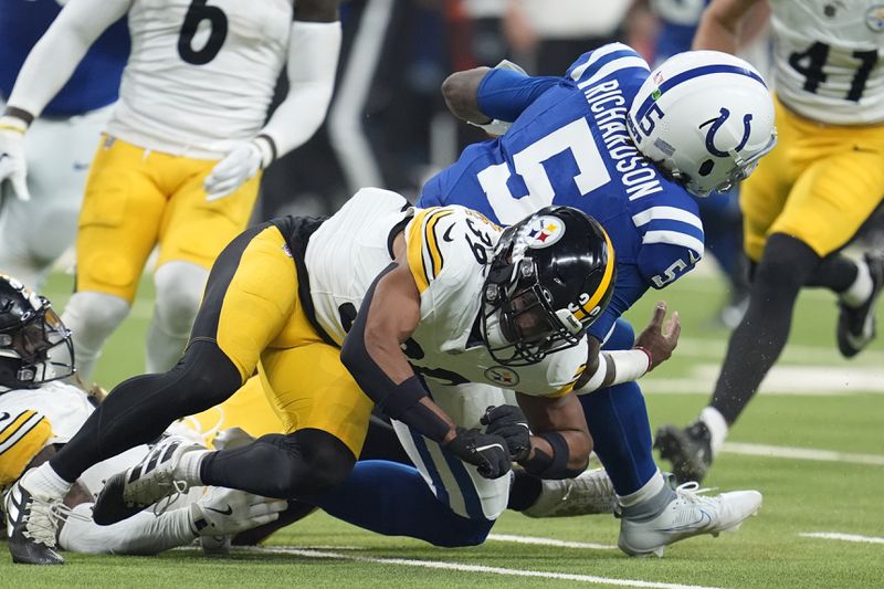 Indianapolis Colts quarterback Anthony Richardson (5) is hit by Pittsburgh Steelers safety Minkah Fitzpatrick (39) at the end of a run during the first half of an NFL football game Sunday, Sept. 29, 2024, in Indianapolis. Richardson left the game with an injury after this play. (AP Photo/Michael Conroy)