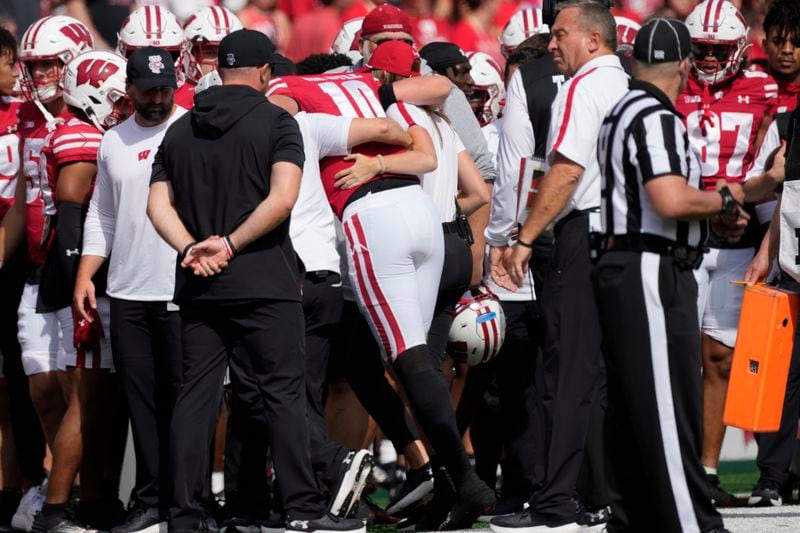 Wisconsin's Tyler Van Dyke (10) is helped off the field during the first half of an NCAA college football game against Alabama Saturday, Sept. 14, 2024, in Madison, Wis. (AP Photo/Morry Gash)