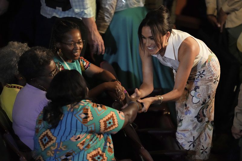 Meghan Markle, Prince Harry's wife, greets people during forum on Afro women and power in Cali, Colombia, Sunday, Aug. 18, 2024. (AP Photo/Ivan Valencia)