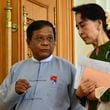 FILE - Zaw Myint Maung, left, an imprisoned politician and a close colleague of Myanmar’s ousted leader Aung San Suu Kyi, right, talks with Suu Kyi at Parliament in Naypyitaw, Myanmar, on July 23, 2015. (AP Photo/Aung Shine Oo, File)