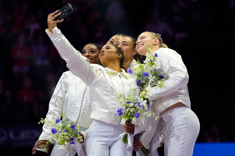 Jordan Chiles takes a selfie with the team after the women were named to the 2024 Olympic team at the United States Gymnastics Olympic Trials on Sunday, June 30, 2024, in Minneapolis. (AP Photo/Abbie Parr)