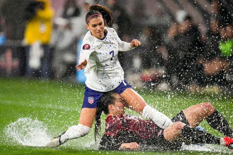 FILE - United States' Alex Morgan, above, collides with Canada's Vanessa Gilles during the first half of a CONCACAF Gold Cup women's soccer tournament semifinal match, Wednesday, March 6, 2024, in San Diego. (AP Photo/Gregory Bull, File)