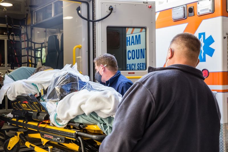 A COVID-19 patient at Northeast Georgia Medical Center is transported by ambulance from the main hospital back to a mobile medical unit after tests. (Jenni Girtman for The Atlanta Journal Constitution)